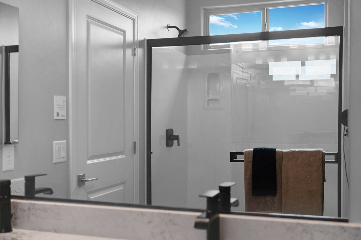 Walk-in shower with marble surround at primary bath