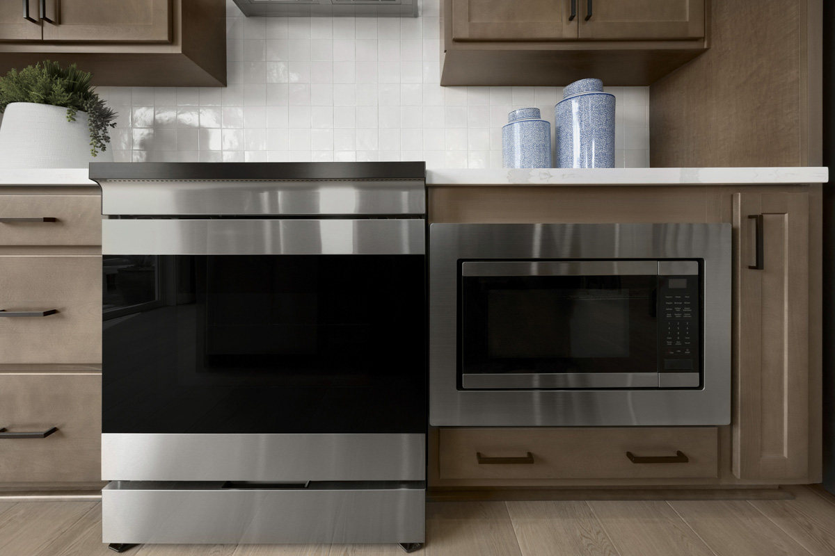 Slide-in range and lower cabinet microwave