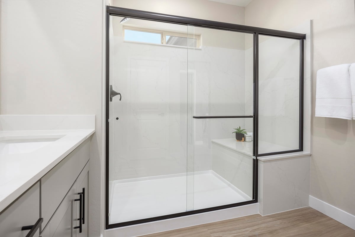 Enlarged walk-in shower with seat at primary bath