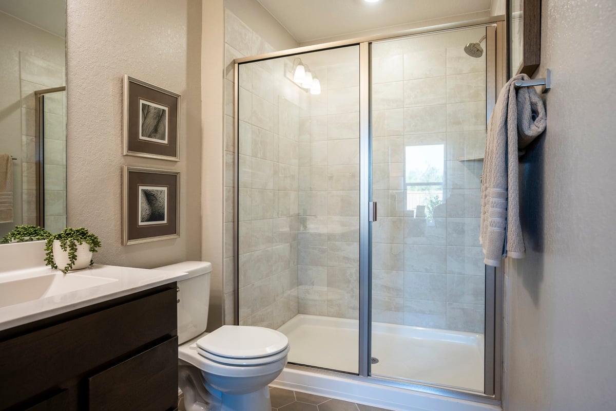 Walk-in shower with tile surround at primary bath