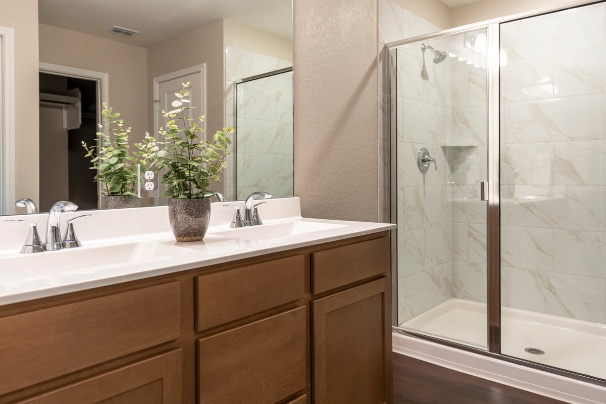 Walk-in shower with tile surround at primary bath